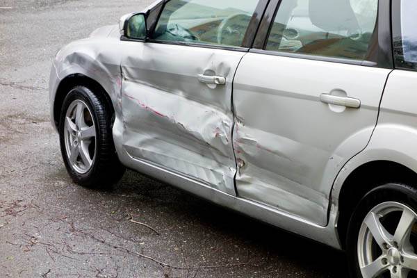 damaged side door of a silver car